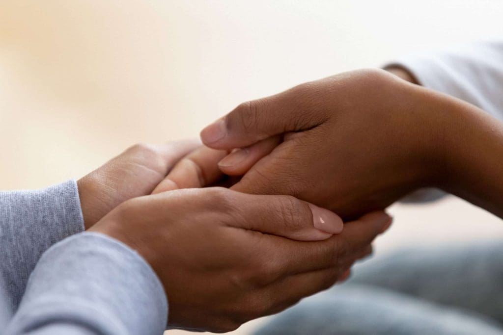 Holding hands caring disability support